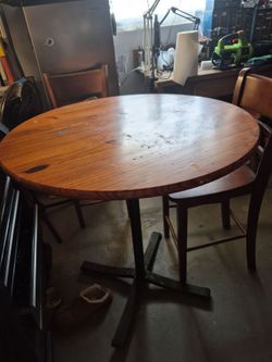 Round wooden table with 2 chairs