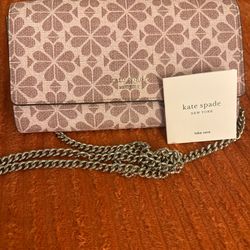 Beautiful signature print bag by Kate Spade New York. Elegant canvas design with the iconic spade pattern and gold logo detail. Comes with original Ka