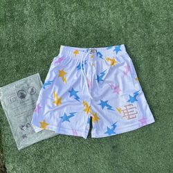 White Eric Emanuel shorts sith pink, blue and yellow stars size medium (brand new)