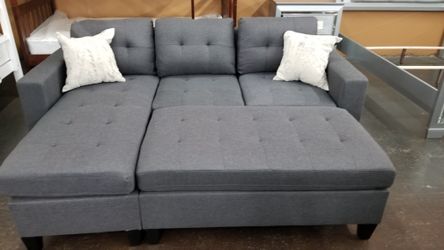 Charcola gray sofa chaise sectional with a large ottoman
