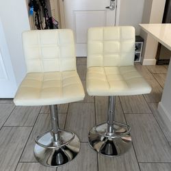 (2) Beige leather counter height bar stools