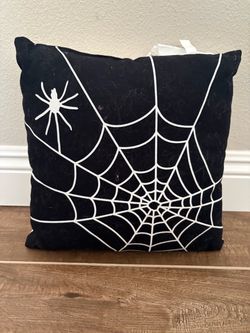 Decorative reversible throw pillow featuring black cursive "Hey Boo