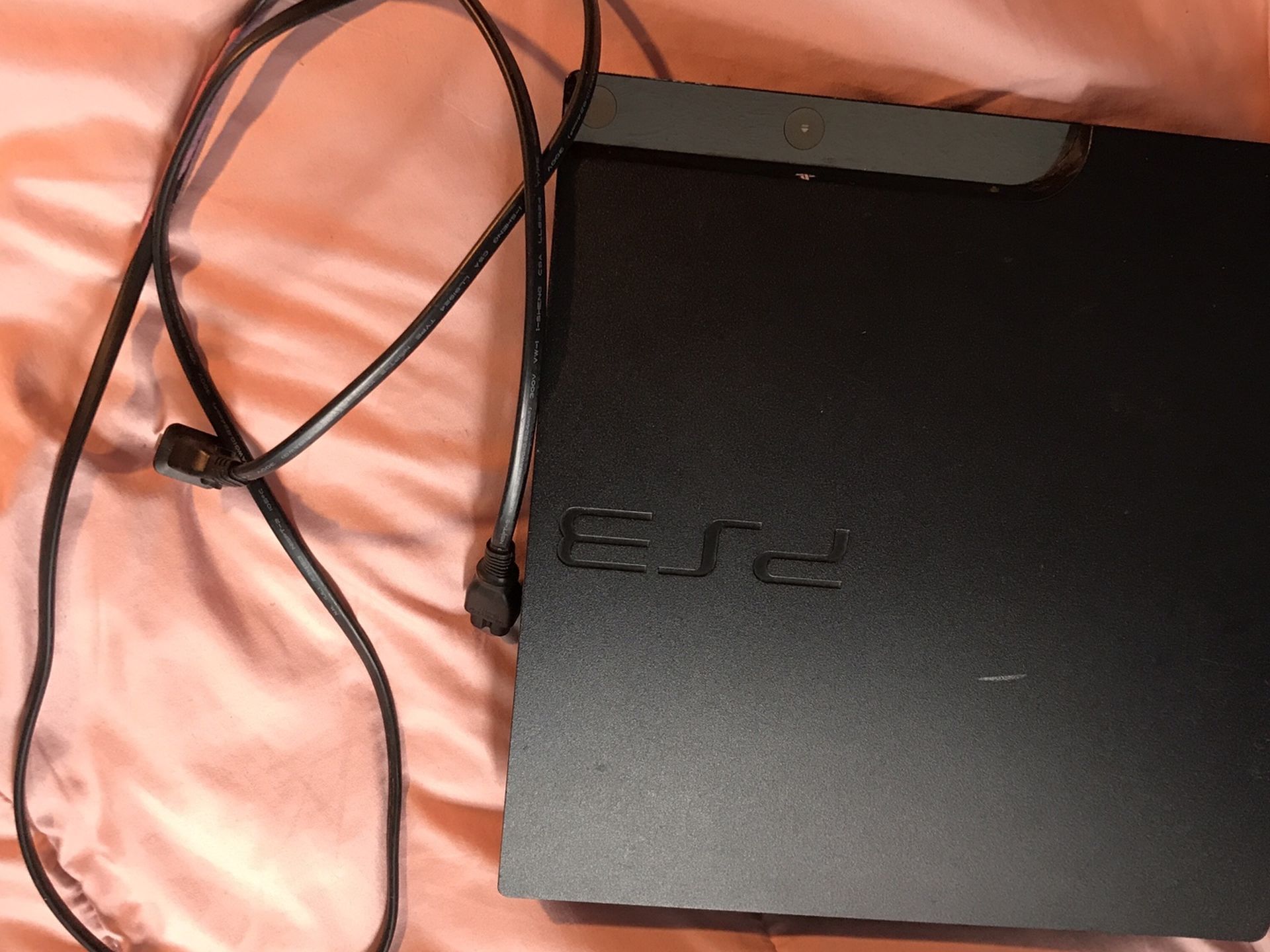 ps3 console with power cord and 2 sony controllers