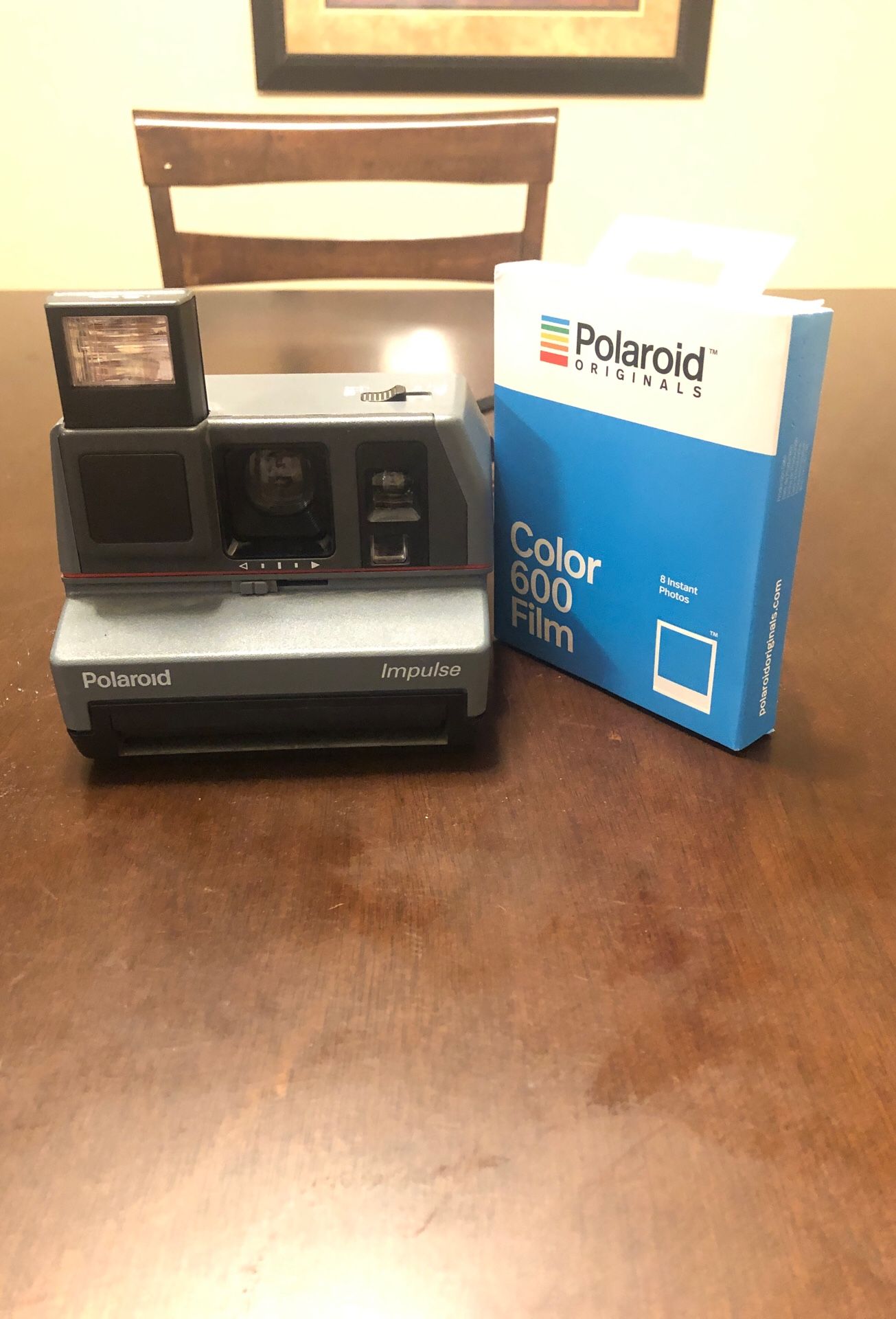 Polaroid impulse camera with film