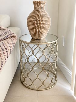 Gold Metal Side Table with Glass Top –20” H x 16.5” Diameter  Elegant round accent/side table with decorative gold metal base and glass top. Great as