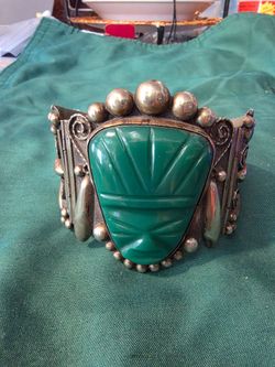 Vintage Alpaca silver cuff bracelet with carved green Mayan-style face.