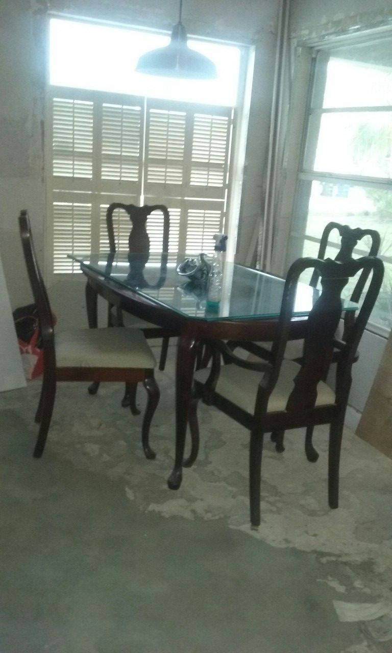 Oval solid wood dining table and four chairs.