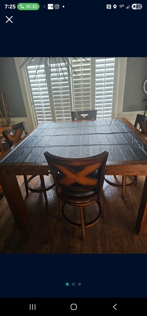 Hardwood  Table With Leather Spin Arond Chairs With Center Pieces  That Can Come To Make The Smaller 