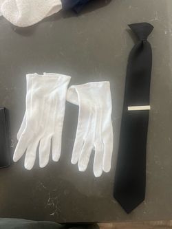 White gloves and black tie with silver tie bar
