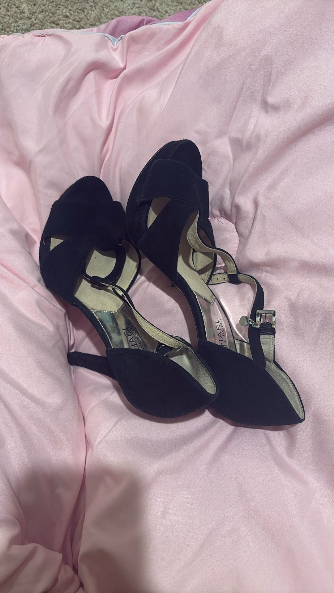 Michael Kors (MK) black suede heels with an ankle strap and block heel.