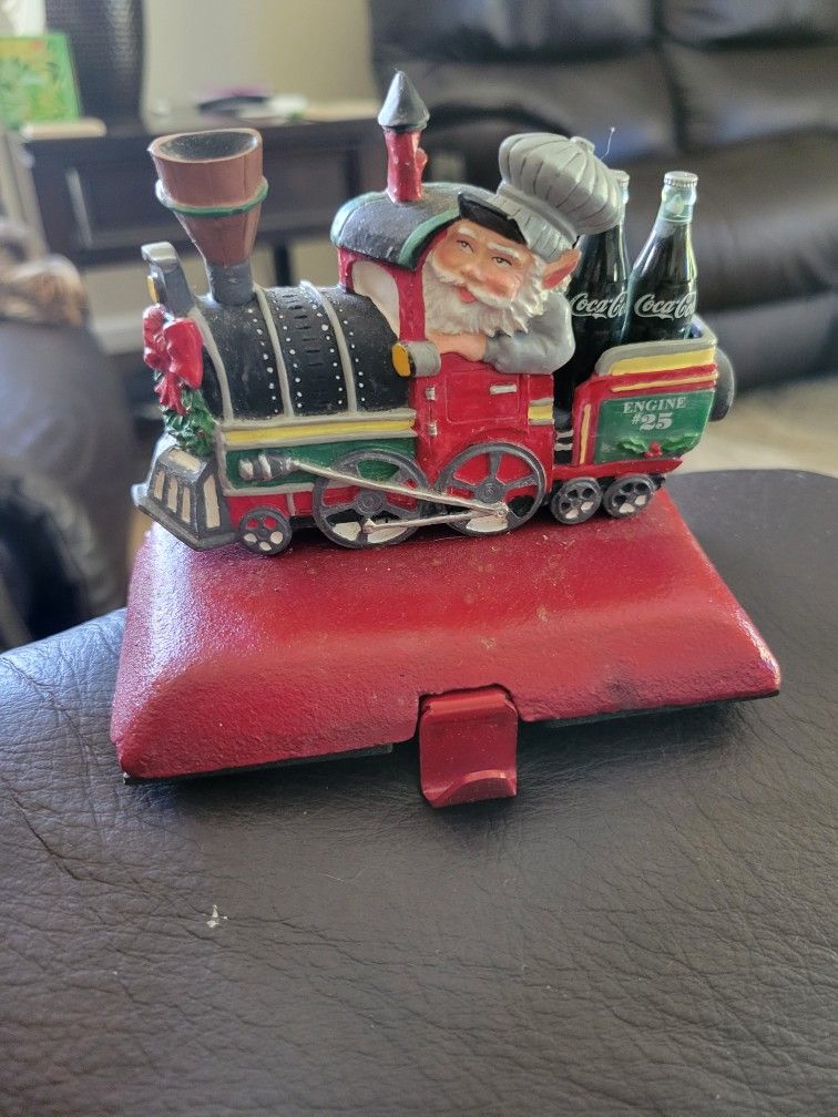1998 Coca-Cola Christmas “North Pole Bottle Works” train stocking holders. Heavy iron base with resin figurine