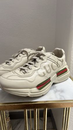 Gucci Rhyton sneakers in ivory leather featuring the vintage logo and signature web stripes.