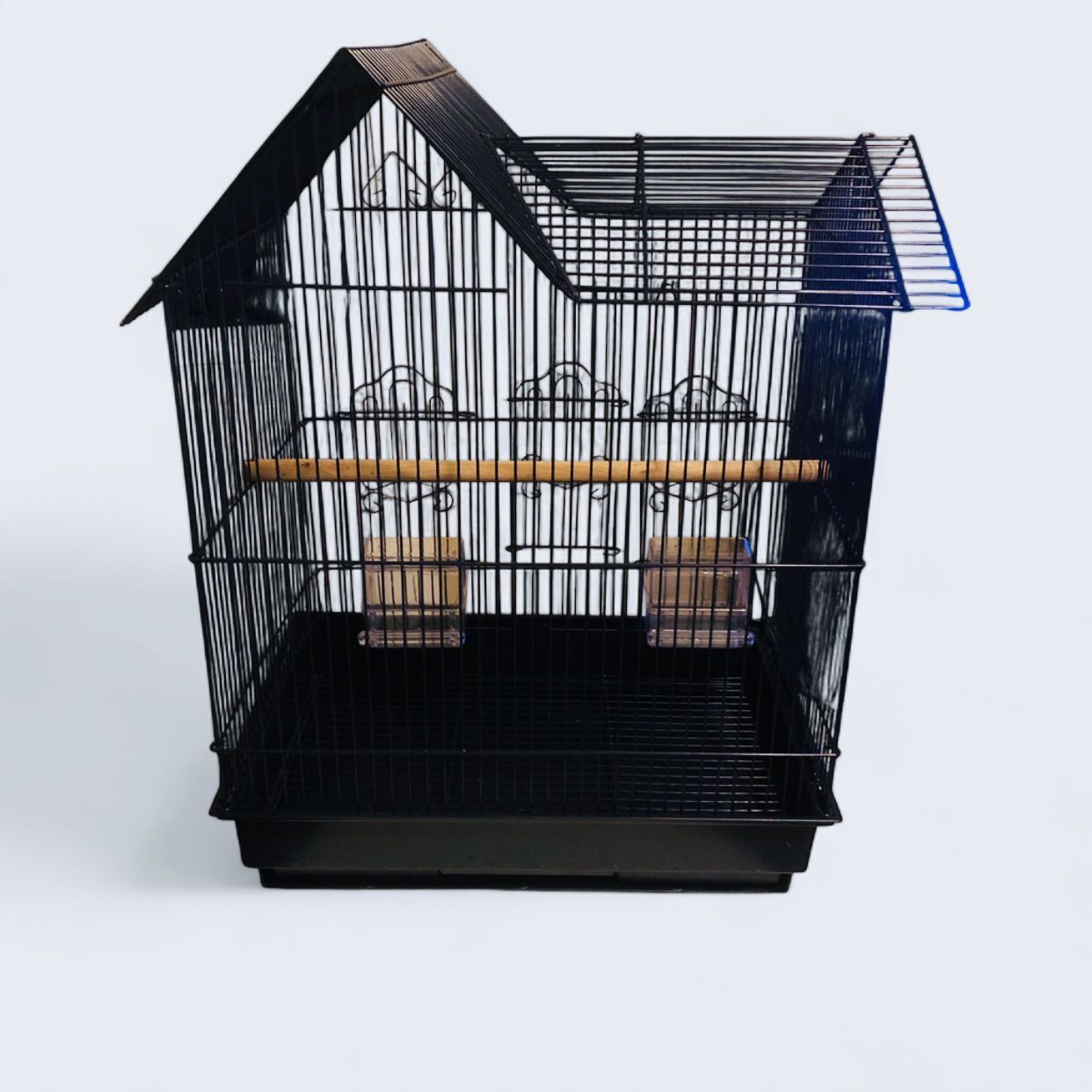 small, black, house-top style bird cage.