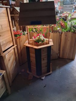 Wishing well Planter with a wooden bucket and a rechargeable light u can remove the bucket and put flowers on the bottom $150 22inchs high x20x20 wide