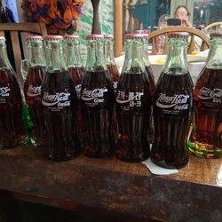 11 Collectors Bottles Of Coca Cola