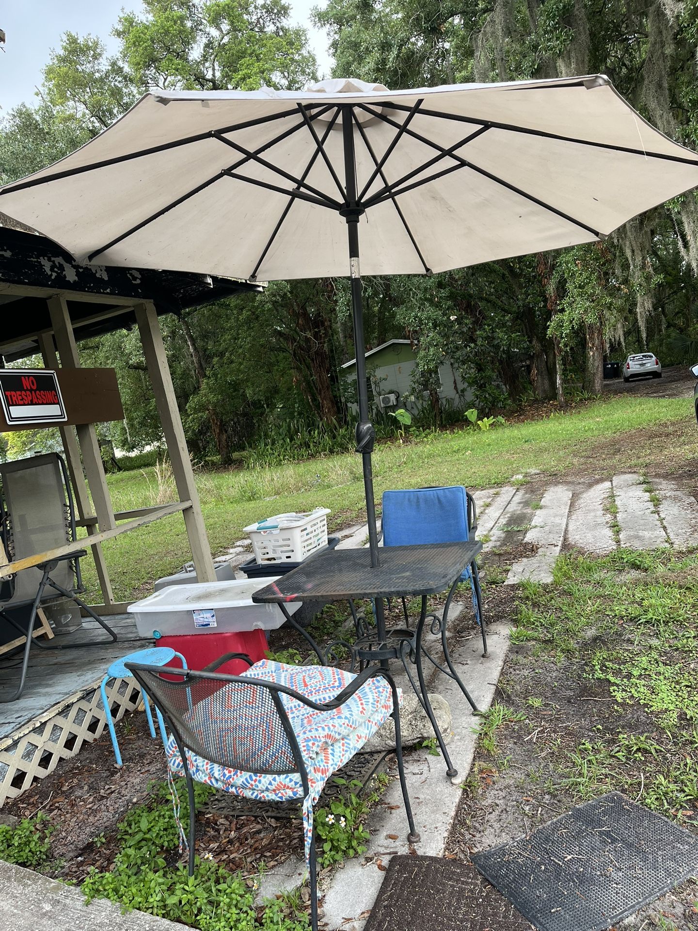 Patio table and chairs and umbrella