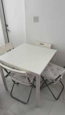 White Dining Table with 4 Folding Chairs & Cushions