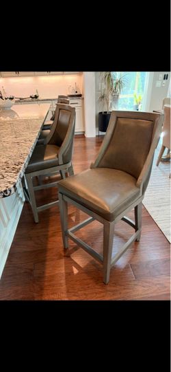 4  grey leather swivel counter bar stools from Grandinroad
