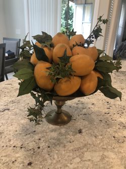 Vase with artificial lemons.