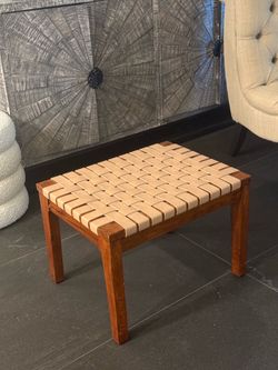 Modern woven stool with a vintage-inspired look.