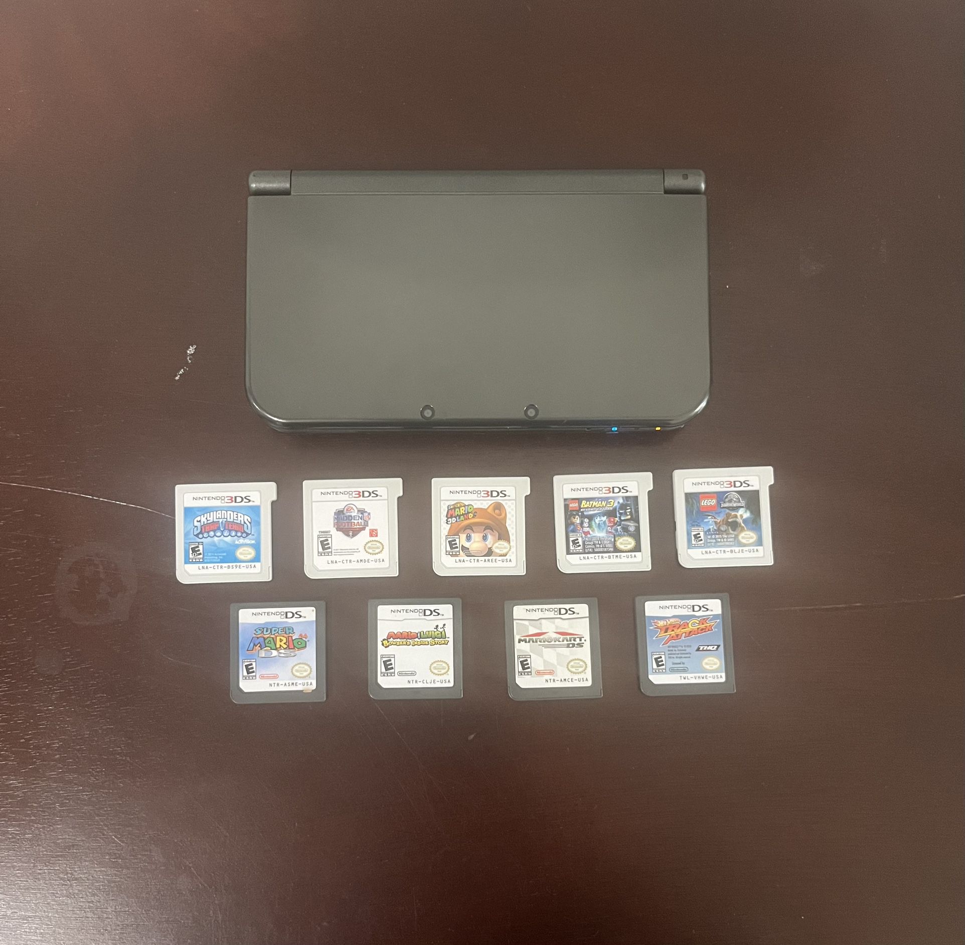 3DS XL with 9 games, a charger, and a case