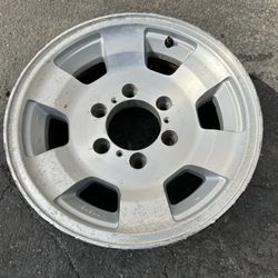 One Isuzu Rodeo 15 inch Aluminum wheel and old tire. 6 lugs