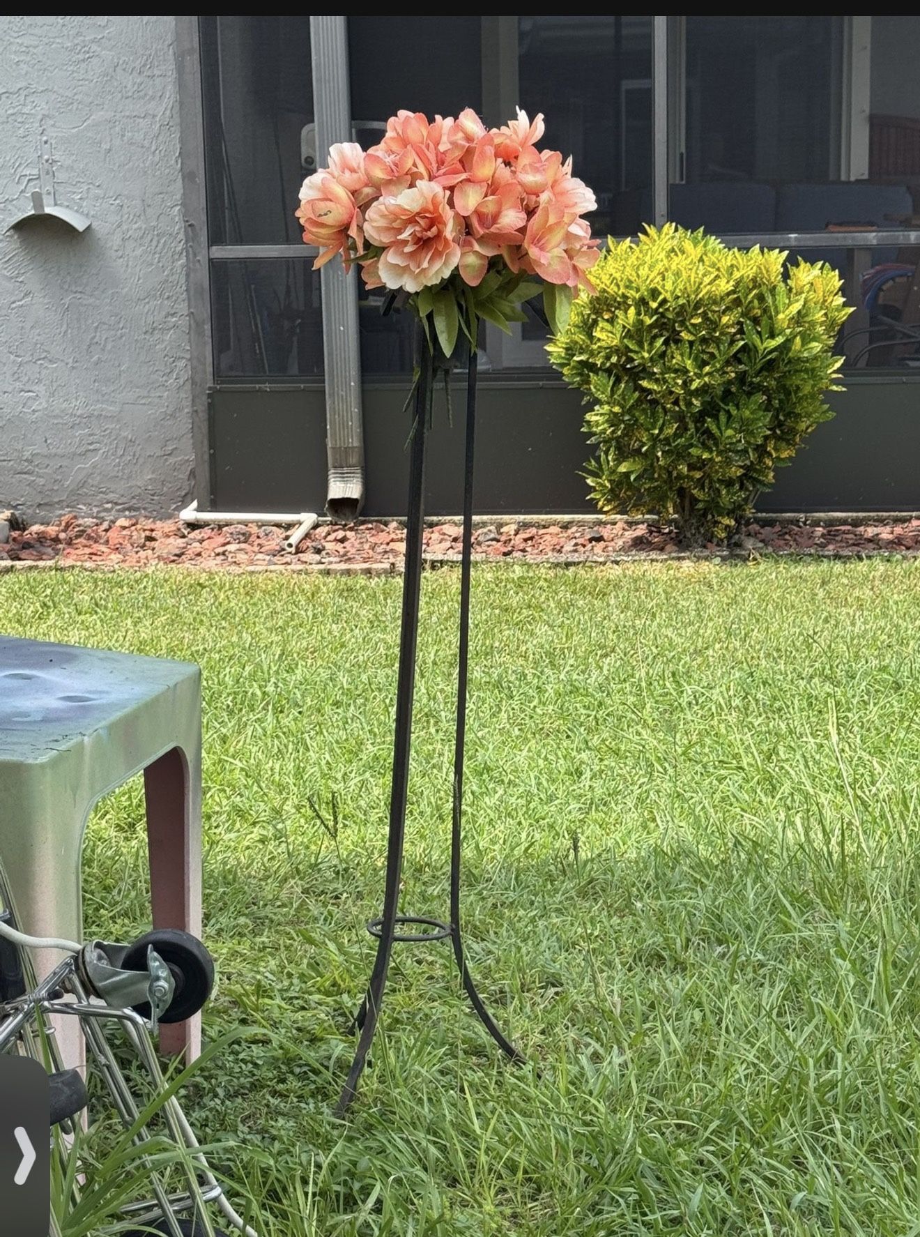 Iron pedestal with fake flowers you can put your own fresh flowers in there or your own fake Flowers Great For Wedding Funeral Cemetery Garden