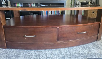 Beautiful, sturdy wood coffee table with a unique curved design and tons of storage!