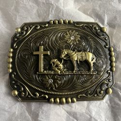 new gold patina western belt buckle featuring a cross and horse flag on the background