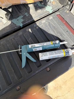 Caulk gun with 2 caulking tubes.