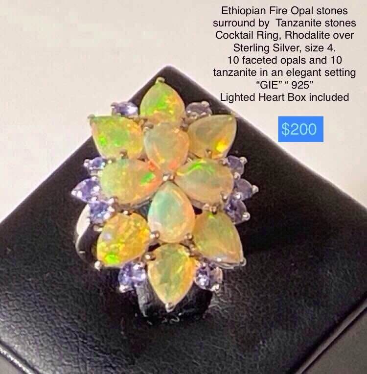 Size 4 Ring, Ethiopian Fire Opal stones surround by Tanzanite stones, Rhodalite over Sterling Silver, awesome ring! Includes heart box