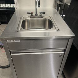 Qualserv portable hand sink with hot water heater on cast...