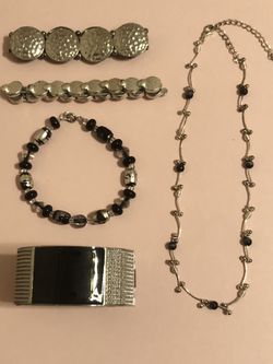 Silver and black jewelry bundle. One short necklace with 3” extender, 2 hammered silver stretch bracelets, one silver and black swirl beaded bracelet