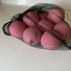 Set of seven brand new pink tennis balls in bag