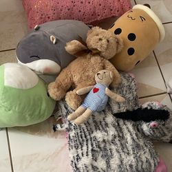 box of stuffed animals and big pickle toy