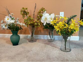 Four vases with beautiful fake flowers