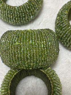Six beaded green napkin ring holders