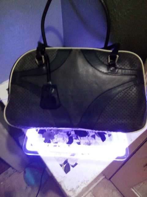 Prada, bowling bag; styled in black leather with white contrast...
