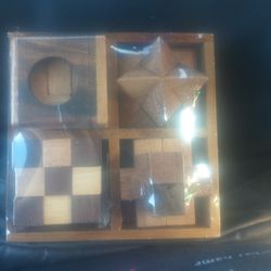 Four Unique Puzzles In A Wooden Box