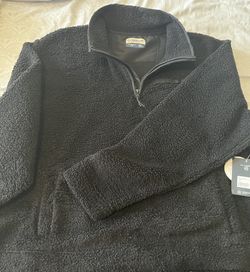 Magellan Outdoors women black sherpa pullover with a cozy, textured fleece. Features a quarter-zip neck for easy layering and a chest zip pocket for s