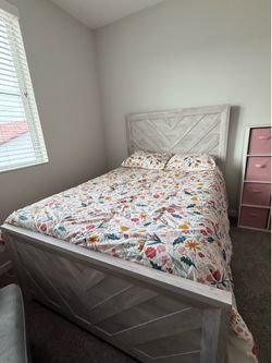 Full size bed, wood headboard and footboard.