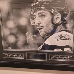 Autographed Patrice Bergeron picture with Game Used Net
