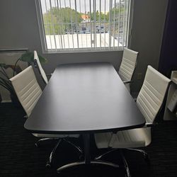Modern conference table with 4 rolling chairs