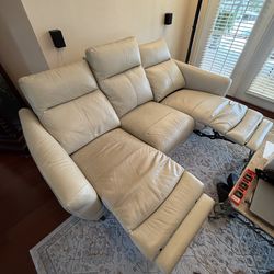 Cream, leather, dual reclining sofa and loveseat.