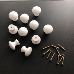 10 White Wooden Dresser Knobs. New condition. Roughly 1 1/2” W/ Hardware