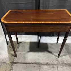 Antique Regency mahogany card table with a cross-banded fold-over top and reeded legs