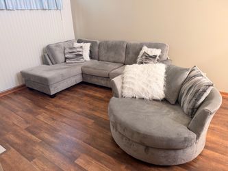 Gray Sectional and Round Swivel Chair