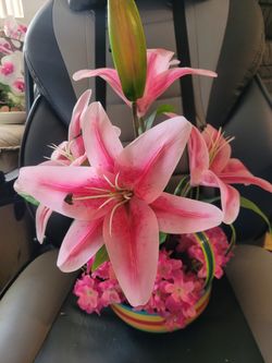 Vintage artificial pink lillies in a striped bowl