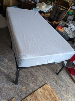 Twin mattress with raised metal frame