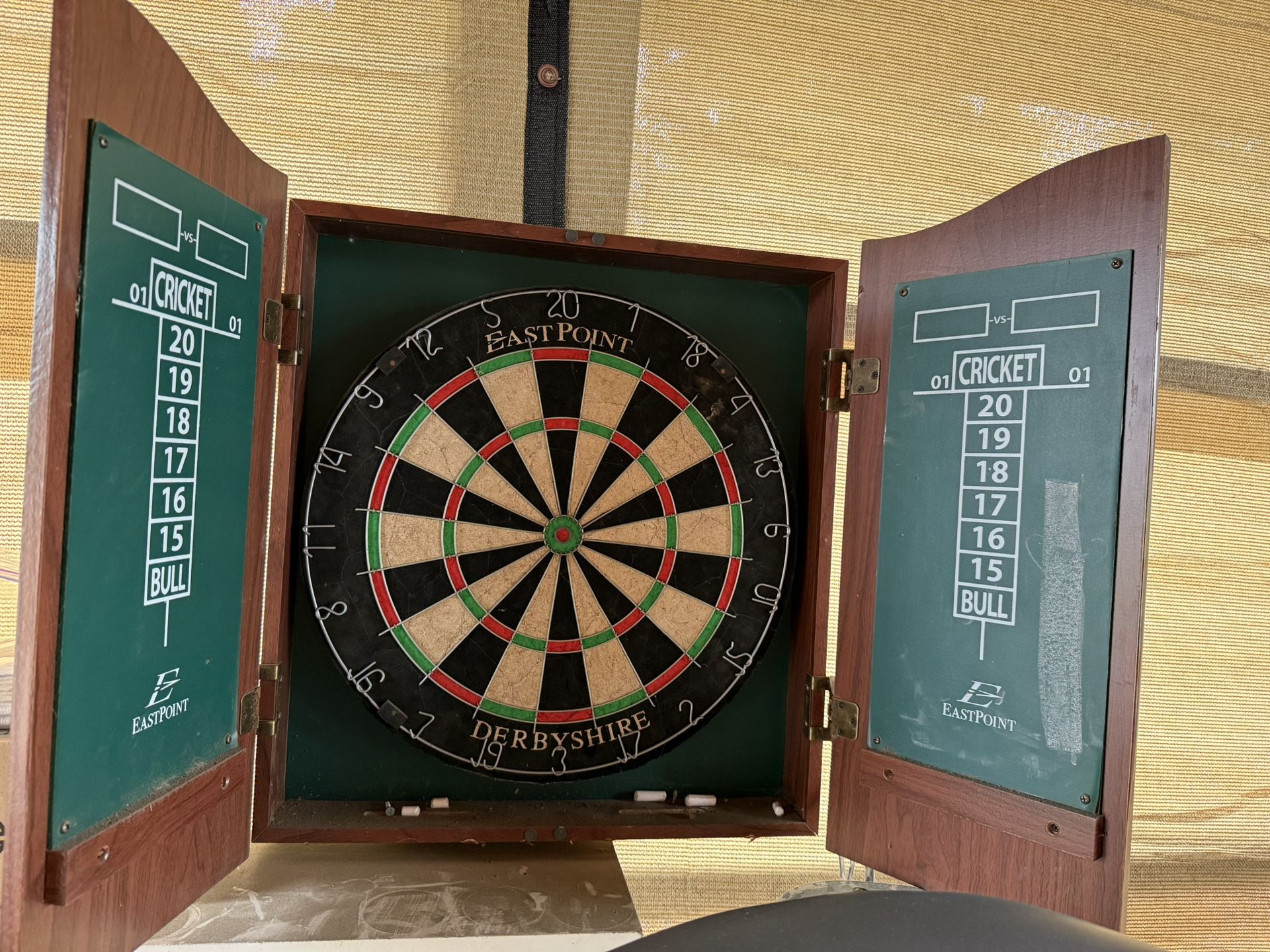 Eastpoint Sports Bristle Dartboard Derbyshire model in a wooden cabinet.
